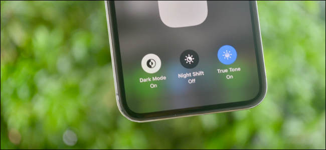 Dark Mode toggle in Control Center shown on an iPhone running iOS 13