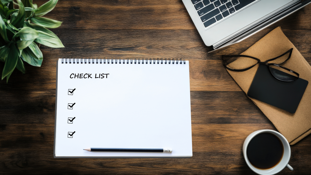 Computer on desk with a checklist